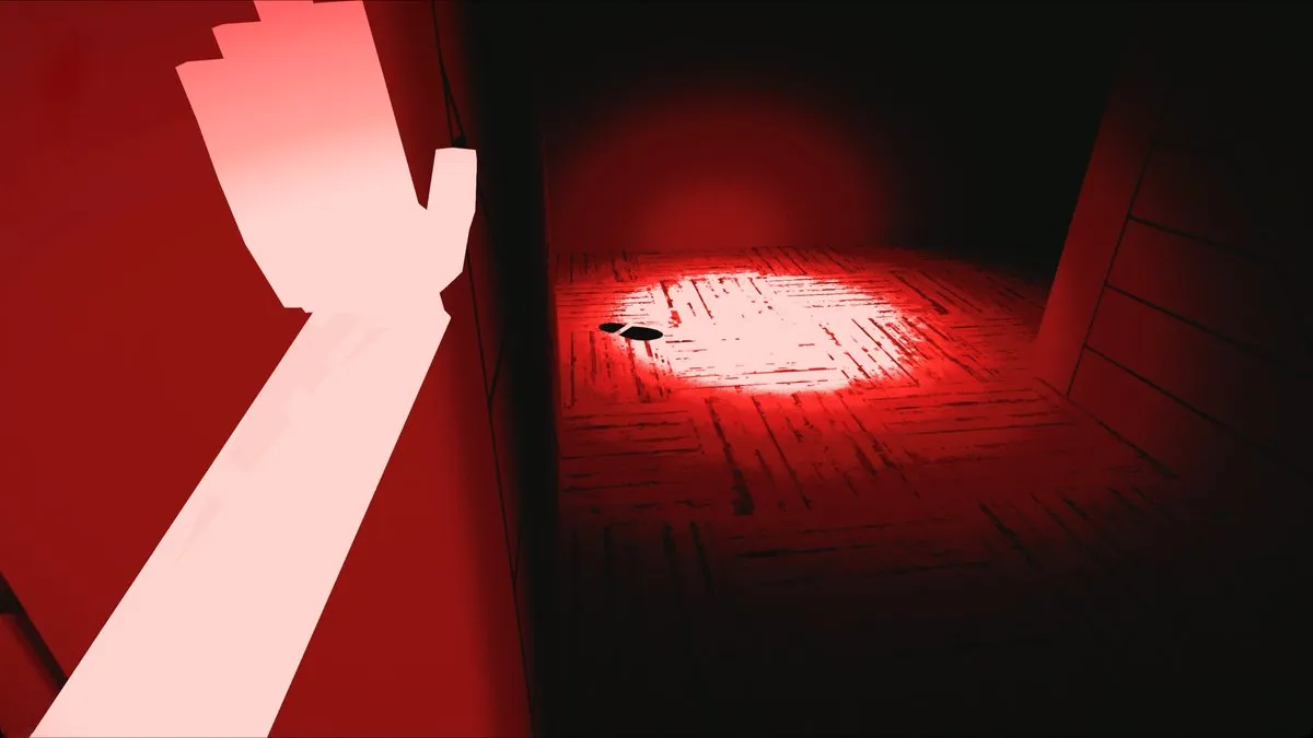 A pale arm reaches past a red-lit floor marked with a footprint
